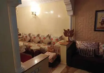 a living room with a bed and a couch at appartement meuble in Marrakech