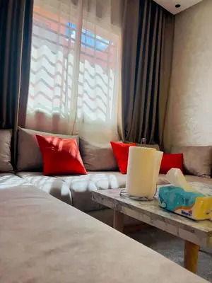 a living room with a couch and a table at Family Apartment in Marrakech in Marrakech