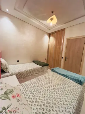 a bedroom with two beds in a room at Family Apartment in Marrakech in Marrakech