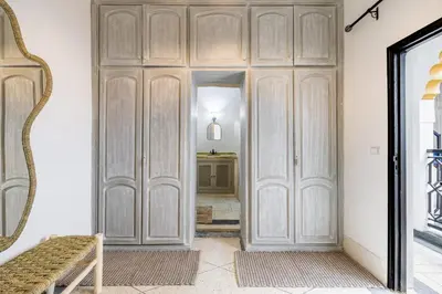 a hallway with a large wooden door in a room at Riad el hana en centre ville rooftop et bassin in Marrakech