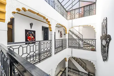 a staircase in a building with balconies at Riad el hana en centre ville rooftop et bassin in Marrakech