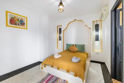 a bedroom with a bed with two stuffed animals on it at Riad el hana en centre ville rooftop et bassin in Marrakech
