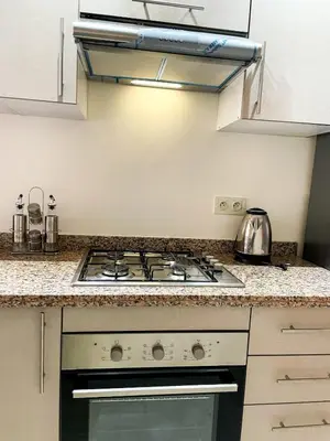 a kitchen with a stove and a counter top at Luxury Aprt 2 bedrooms Pool Hivernage City Centre in Marrakech