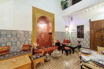 a living room with a table and chairs at Riad Khadoj-Marrakech-Traditional in Marrakech