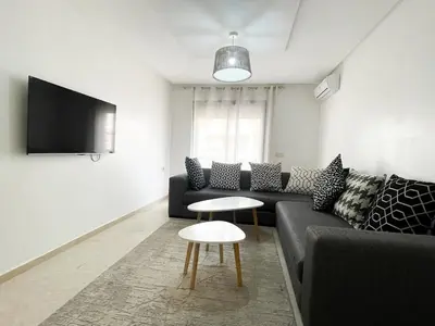a living room with a couch and a table at luxury Aprt2-bedrooms Pool hivernage heart of city in Marrakech