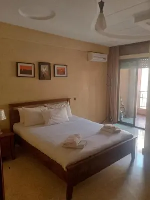a bedroom with a bed with two towels on it at Appartement au cœur de Gueliz in Marrakech