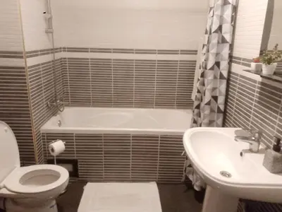 a bathroom with a tub and a toilet and a sink at Appartement au cœur de Gueliz in Marrakech