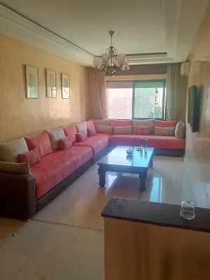 a living room with a red couch and a coffee table at Appartement au cœur de Gueliz in Marrakech