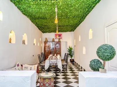 a dining room with a green ceiling at Riad Sifaw & Spa Marrakech in Marrakech