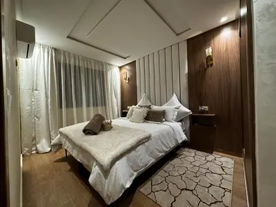 a hotel room with a bed with a teddy bear on it at Super duplex in the middle of Marrakech in Marrakech