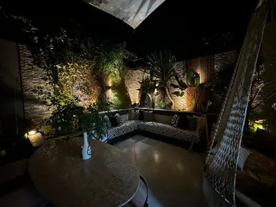 a table and chairs in a room with plants at Super duplex in the middle of Marrakech in Marrakech