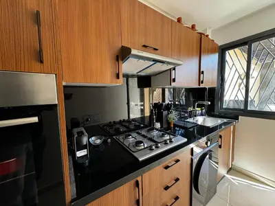 a kitchen with a stove top and a sink at Super duplex in the middle of Marrakech in Marrakech