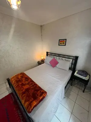 a bedroom with a bed with a blanket on it at Riad 49 G26 in Marrakech