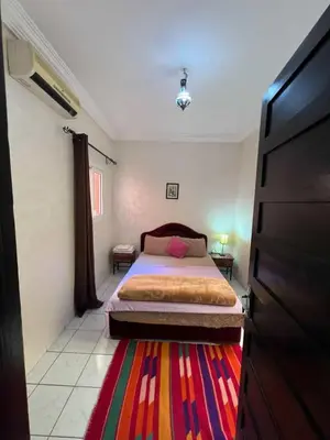 a bedroom with a bed and a colorful rug at Riad 49 G26 in Marrakech