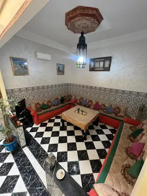 a living room with dolls sitting on a couch at Riad 49 G26 in Marrakech