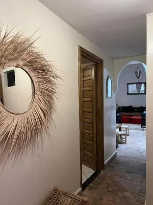 a hallway with a round mirror on a wall at LOGEMENT ENTIER MARRAKECh G4 N41 in Marrakech