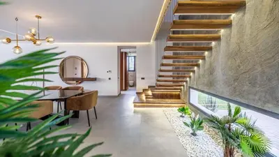 a staircase in a house with a table and chairs at Villa jardin atlas in Marrakech