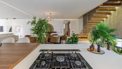 an open living room with a stove and a staircase at Villa jardin atlas in Marrakech
