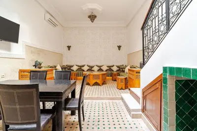 a dining room with a table and chairs at Riad TESS in Marrakech