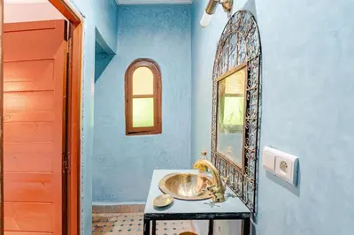 a bathroom with a sink and a mirror at Riad TESS in Marrakech