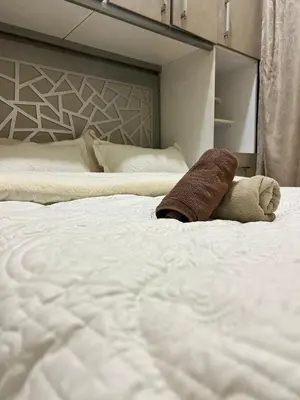 a large white bed with a stuffed animal on it at Cozy Stay Close to Downtown in Marrakech