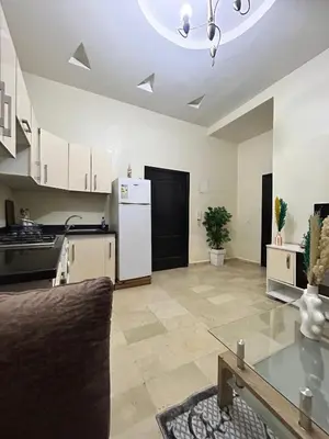 a large kitchen with a couch and a refrigerator at Cozy Stay Close to Downtown in Marrakech