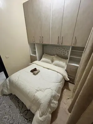 a small bedroom with a bed with white cabinets at Cozy Stay Close to Downtown in Marrakech