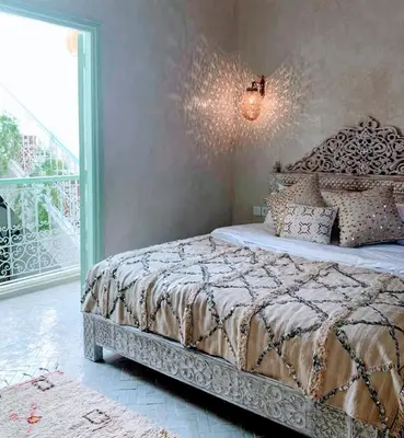 a bedroom with a bed with a large window at Riad with 3 Swimming Pools in Marrakech