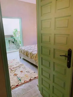 a door to a bedroom with a bed and a window at Riad with 3 Swimming Pools in Marrakech