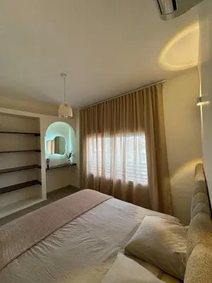 a bedroom with a large bed and a window at KL Home- au cœur du centre ville moderne in Marrakech