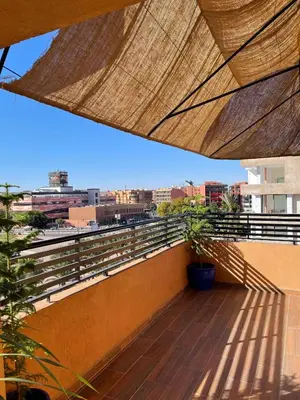 a balcony with a view of a city at KL Home- au cœur du centre ville moderne in Marrakech
