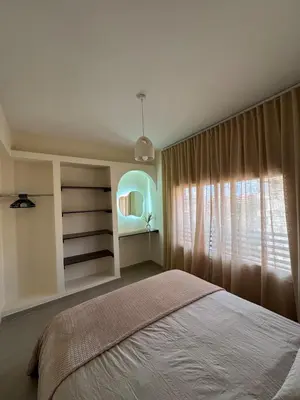 a bedroom with a large bed and a window at KL Home- au cœur du centre ville moderne in Marrakech