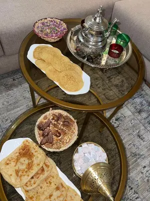 a glass table with various types of bread on it at KL Home- au cœur du centre ville moderne in Marrakech