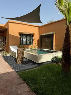 a house with a swimming pool in the yard at Cozy, Intimate Villa in Marrakech with Heated Swimming Pool Option in Touggana