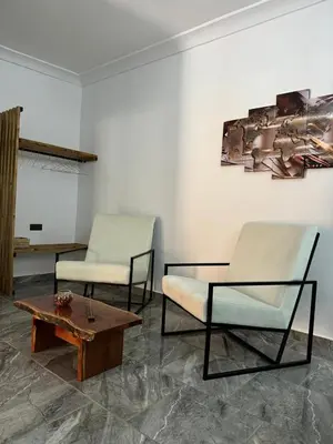 two chairs and a coffee table in a room at Cozy, Intimate Villa in Marrakech with Heated Swimming Pool Option in Touggana