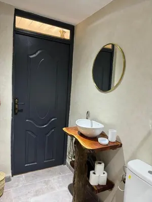 a bathroom with a black door and a sink at Cozy, Intimate Villa in Marrakech with Heated Swimming Pool Option in Touggana