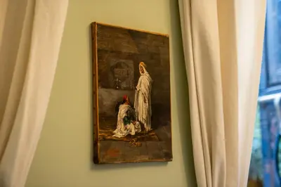 a painting hanging on a wall next to a window at Riad Al Scarabi in Marrakech