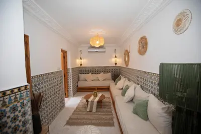 a living room with a couch and a table at Riad Näjma Medina, privatisation, 8 personnes 2 Bassins in Marrakech