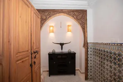 a hallway with an archway and a table in a room at Riad Näjma Medina, privatisation, 8 personnes 2 Bassins in Marrakech