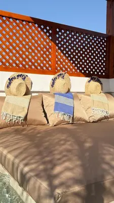 a bed with two pillows on top of it at Riad Näjma Medina, privatisation, 8 personnes 2 Bassins in Marrakech