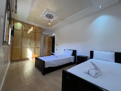 a hotel room with two beds with a dog on them at Villa Soufia in Marrakech