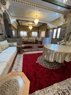 a living room with a couch and a red rug at Villa Soufia in Marrakech