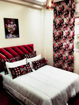a bedroom with a large bed with a red headboard at Betterappart in Marrakech
