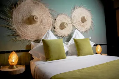 a bedroom with a bed and some baskets on the wall at Riad FARASHA in Marrakech