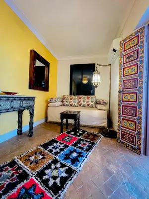 a living room with a couch and a table at Riad FARASHA in Marrakech