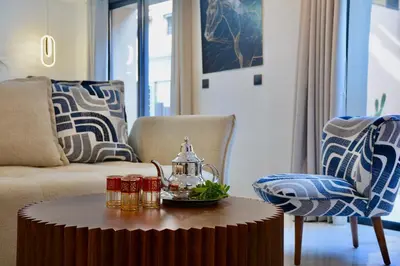 a living room with a coffee table with a tea kettle at Duplex Safiya Suites and Services in Marrakech