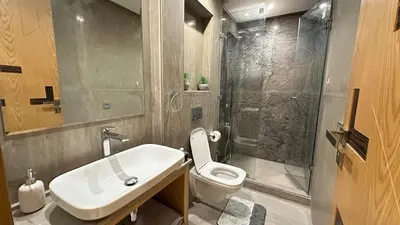 a bathroom with a toilet and a sink and a shower at NEW LUXURY APARTMENT - HEART Of MARRAKECH in Marrakech
