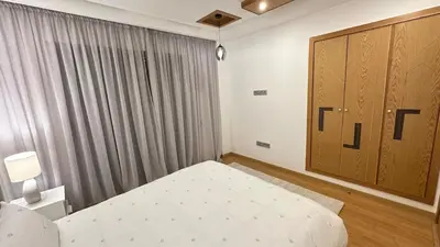 a bedroom with a bed and a large window at NEW LUXURY APARTMENT - HEART Of MARRAKECH in Marrakech