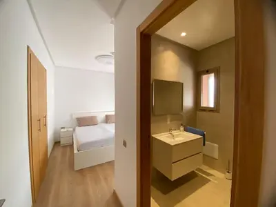 a bathroom with a sink and a bed at Breathtaking views of golf in Marrakech