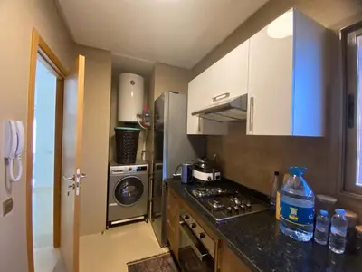 a small kitchen with a stove and a refrigerator at Breathtaking views of golf in Marrakech